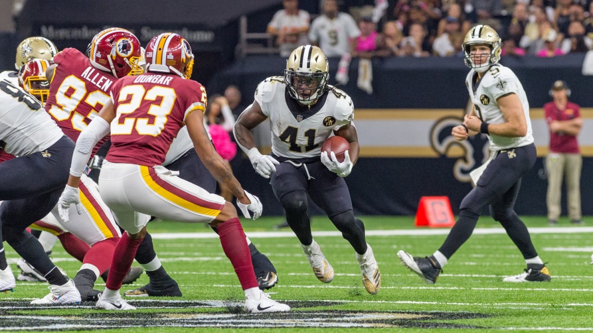 New Orleans Saints running back Alvin Kamara (41) runs the ball against Washington Redskins defensive end Jonathan Allen (93) and cornerback Quinton Dunbar (23). Mandatory Credit: Scott Clause/The Advertiser via USA TODAY NETWORK